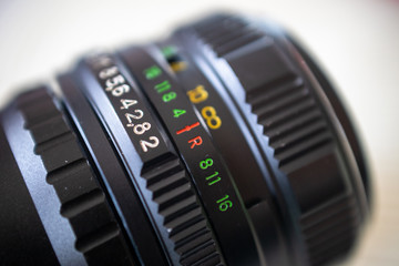 Old vintage manual photo lens with adapter for modern mirrorless camera