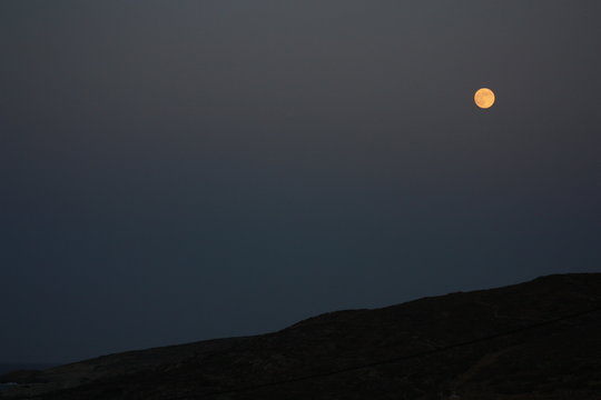The colors of Mediterranean  spring with full moon rising over Eastern Crete