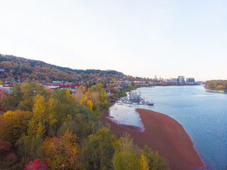 Autumn scenery over the river, overlooking the city. Shot from a height