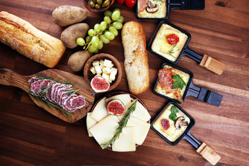 Delicious traditional Swiss melted raclette cheese on diced boiled or baked potato.