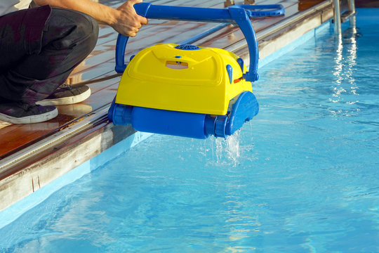 Pool cleaner during his work. Cleaning robot for cleaning the botton of swimming pools. Automatic pool cleaners.     