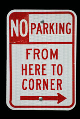 Sign for NO PARKING zone; isolated on black