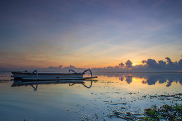 boat on beach at sunrise