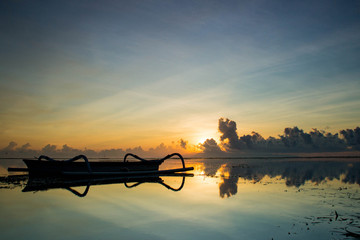 Fototapeta na wymiar Fishing Boats on the Sea against the Background of Sunrise and Sunlight