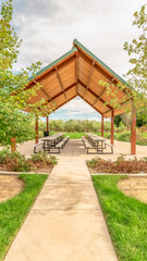 Vertical Beautiful view of a picnic pavilion at a park with pathway and trees in front