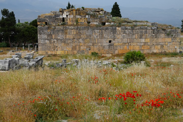 remains of the ancient antique buildings of Hierapolis from limestone blocks, dilapidated walls.