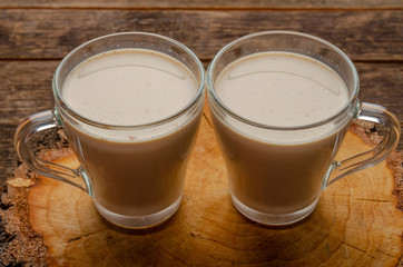 Indian masala chai on rustic wooden table. two