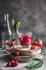 Strawberries in water on a dark gray background. Healthy food, fruit.