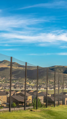 Vertical frame Residential houses and mountain on the other side of the golf course fence