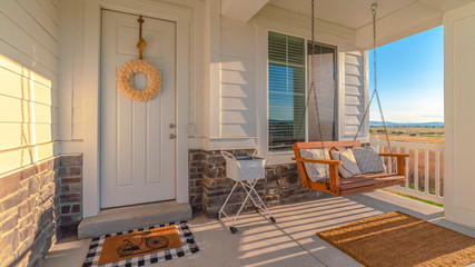 Panorama frame Front porch of modern home with swinging chair