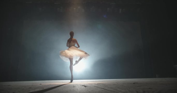 Beautiful artist performing, dancing ballet on spotted stage, choreographer setting a performance, isolated on black background - arts concept 4k footage
