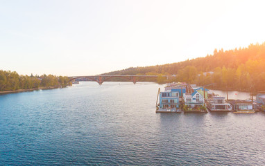 A pier with houses on the water in the USA at sunset in autumn, shot from above using a drone