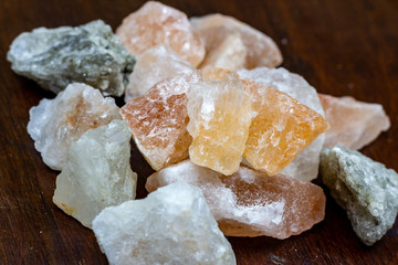 Himalayan lamp white and pink salt crystals for therapy on wooden background.