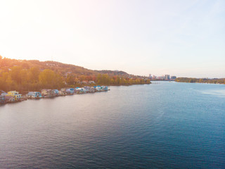 Autumn sunset with a bridge over the river, landscape shot from a height