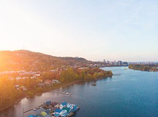 A pier with houses on the water in the USA at sunset in autumn, shot from above using a drone