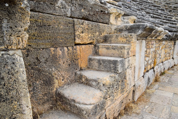 The steps of the amphitheater. Stone limestone and marble. Ancient antique amphitheater in city of Hierapolis in Turkey