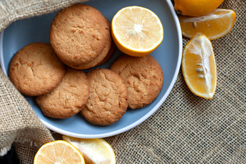 lemon cookies made at home, citrus baking deliciously lies on a plate in the fabric, view from the top