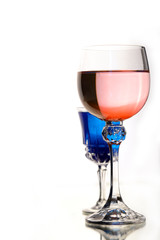 rose wine and blue coctail in beautiful vintage crystal glasses on white wall background, with copy space. Wine list, bar drink menu, wine boutique or degustation, Vertical crop concept
