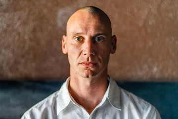 young man short hair bold portrait wearing white shirt side light real people