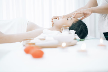 Beautiful young woman lying down on beds massage and spa at asian spa massage and beauty salon center, spa concept, massage concept
