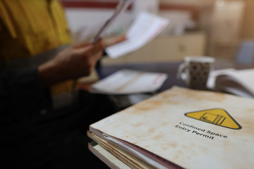 Defocused of miner contractor seating on the chair double checking of Job hazard analysis (JSA)...