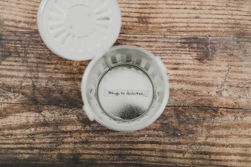 garbage bin with label saying Things to Declutter