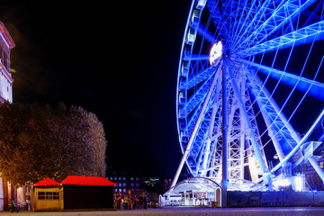 Night scenery with long exposure shot of promenade riverside of Rhine river with spinning ferris...