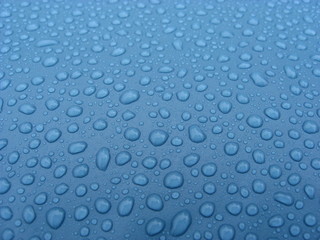 rain droplets on blue pool plastic