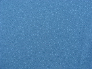 Water droplets on blue pool plastic
