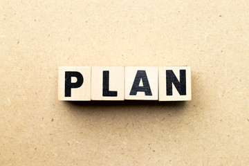 Letter block in word plan on wood background