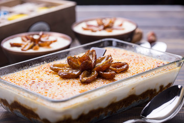 Creme brûlée's Vanilla date pudding on a glass serving dish on a wooden table