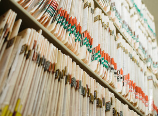 medical record charts on shelve sorted alphabetically