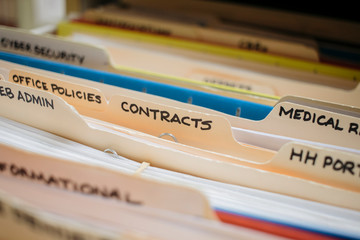 medical record charts on shelve sorted alphabetically