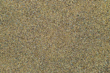 Mixed sand surface with various minerals visible in close up.