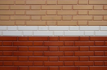 Glazed brick surface, empy space for backgrounds or backdrops, two shades of brown with a white belt in the middle.