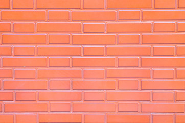 Pale red glazed brick surface, empy space for backgrounds or backdrops.