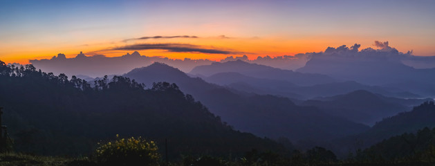 Obraz premium Sunset or sunrise mountain peaks colorful sky panorama.