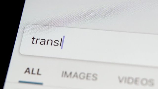 "Translate " Typing into Search Engine on smartphone  Screen. Internet Search Engine Screen Close-Up. learning languages concept , translate website and application .