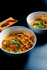 Khao Soi Chicken, a Thai food that is widely popular in the north along with the side dishes.