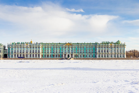 Unusual view on Hermitage Winter palace from Neva river covered with snow with walking paths Saint-Petersburg, Russia