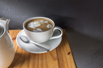 cup of coffee on wooden table