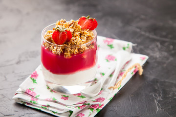 breakfast in a glass - yogurt, jam and muesli, selective focus, copy space