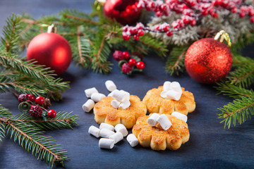 cookies about marshmallows and Christmas balls on a table, selective focus, copy space