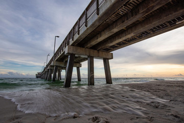 Tide coming in under a pier