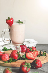 strawberry smoothie with mint on the table, front view