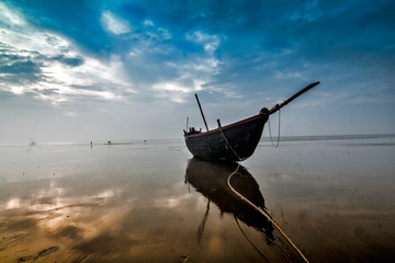 A fishing boat at the sea shore after completing task