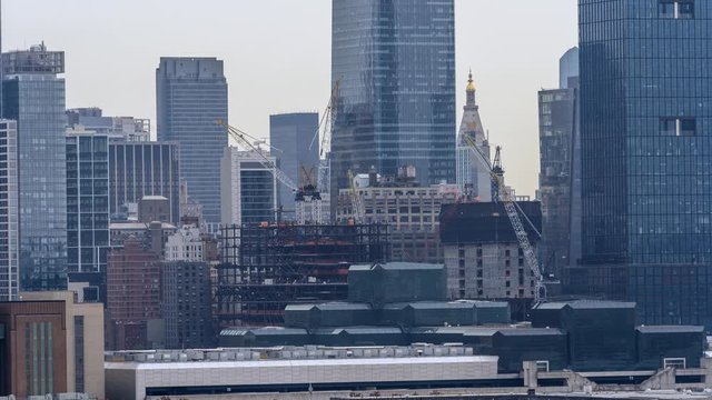Aerial time lapse footage of Construction in New York City. The Shot includes cranes operating in the foreground with the MetLife Tower visible in the background.