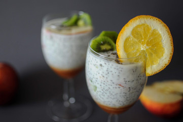Healthy chia pudding in a glass with fresh fruits and honey