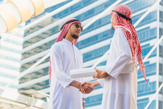 Arabian Business Man And Engineer Consultant Shaking Hands On Construction Site After Check Out The New Project With Blueprint, Middle East New Project And Business Trip