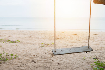 Wood swing at the beach and sand